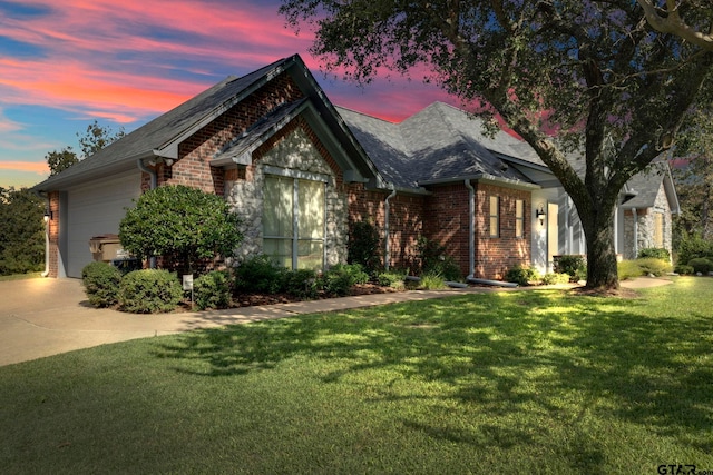 view of front of home with a garage and a yard