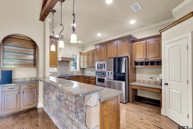 kitchen featuring pendant lighting, kitchen peninsula, stainless steel appliances, and light hardwood / wood-style floors