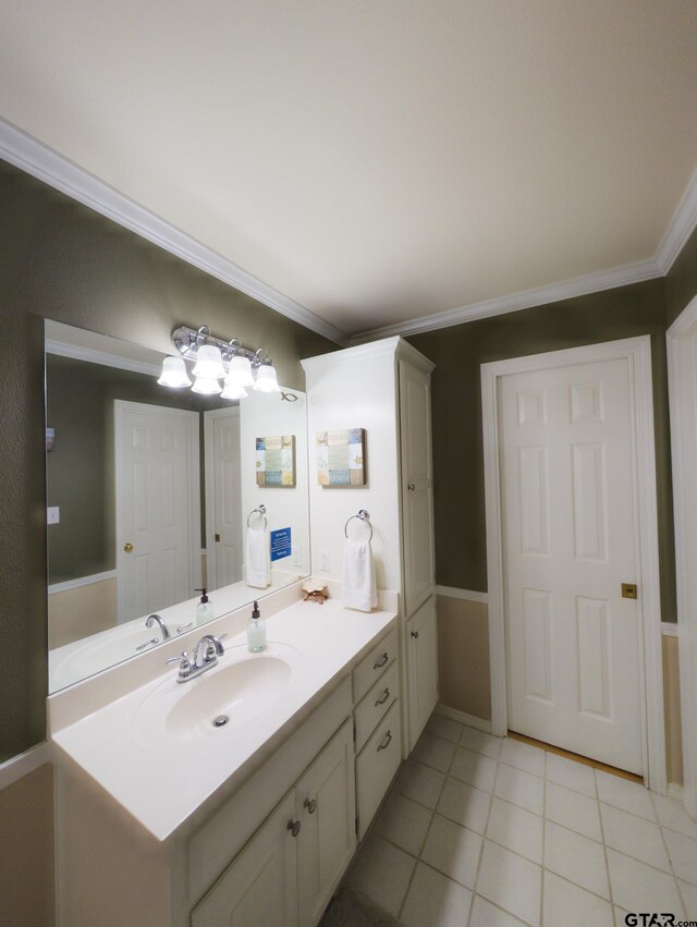 bathroom with crown molding, vanity, and tile patterned floors