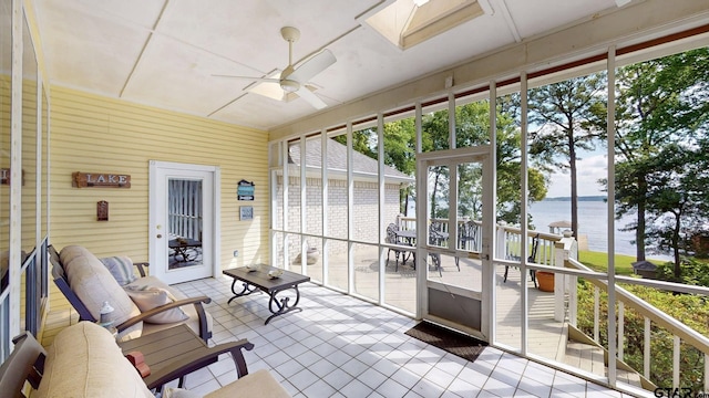 sunroom / solarium with a skylight, a water view, and ceiling fan