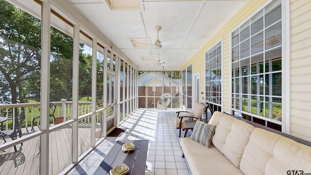 sunroom / solarium featuring a wealth of natural light and a ceiling fan