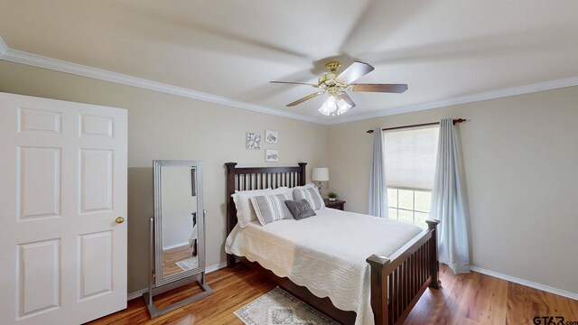 bedroom with baseboards, a ceiling fan, wood finished floors, and crown molding