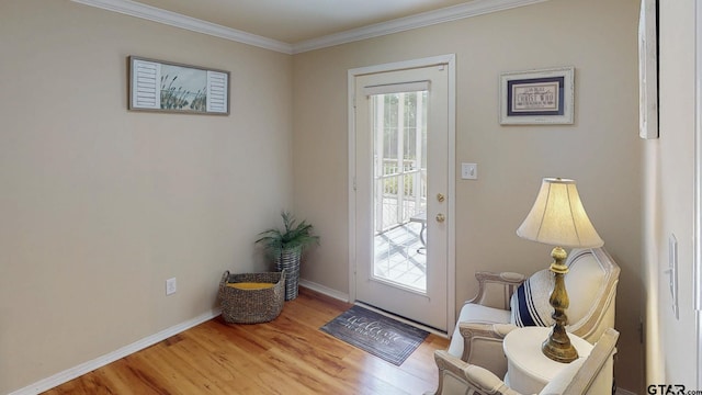 doorway featuring wood finished floors, baseboards, and ornamental molding