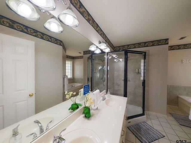 bathroom with a garden tub, tile patterned floors, a stall shower, and a sink