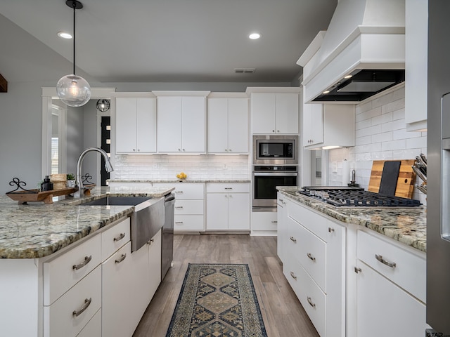 217 Providence Pl, Bullard, TX 75757 - kitchen featuring stainless steel appliances, premium range hood, tasteful backsplash, hanging light fixtures, and recessed lighting