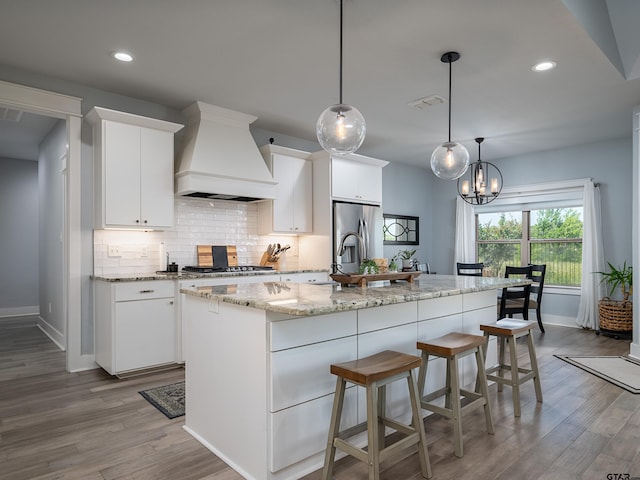 217 Providence Pl, Bullard, TX 75757 - kitchen featuring custom range hood, wood finished floors, stainless steel appliances, white cabinets, and recessed lighting