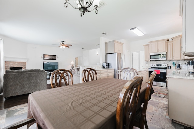 224 Cass Cir, Flint, TX 75762 - dining space featuring a ceiling fan, a chandelier, and a fireplace