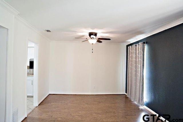 unfurnished room featuring hardwood / wood-style flooring, ornamental molding, and ceiling fan