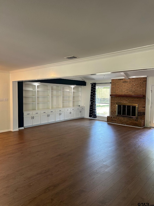715 Belmont Dr, Athens, TX 75751 - unfurnished living room with crown molding, dark wood-style floors, and a brick fireplace