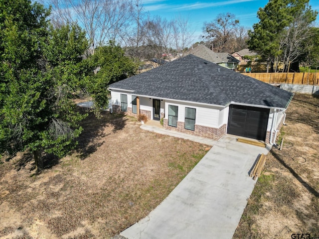 ranch-style home featuring a garage and a front lawn