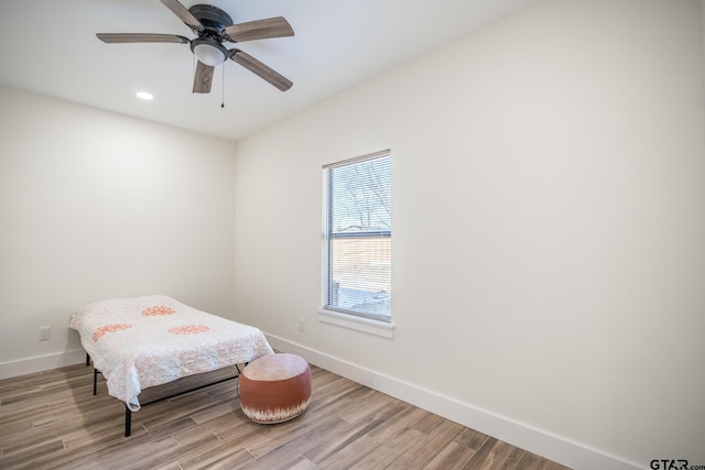 bedroom with hardwood / wood-style floors and ceiling fan