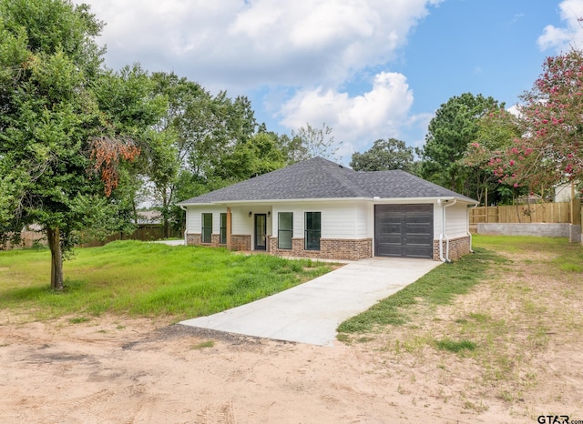 view of front of home featuring a garage and a front lawn