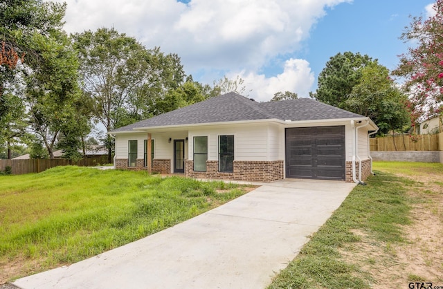 view of front of home with a front yard and a garage