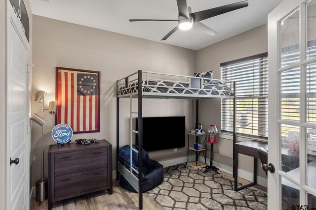 bedroom with ceiling fan and wood-type flooring