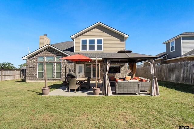 back of house featuring a gazebo, outdoor lounge area, a lawn, and a patio