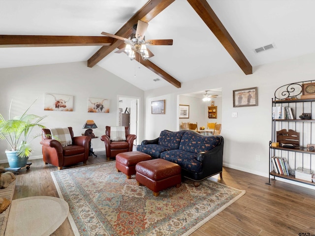 living room featuring vaulted ceiling with beams and hardwood / wood-style flooring