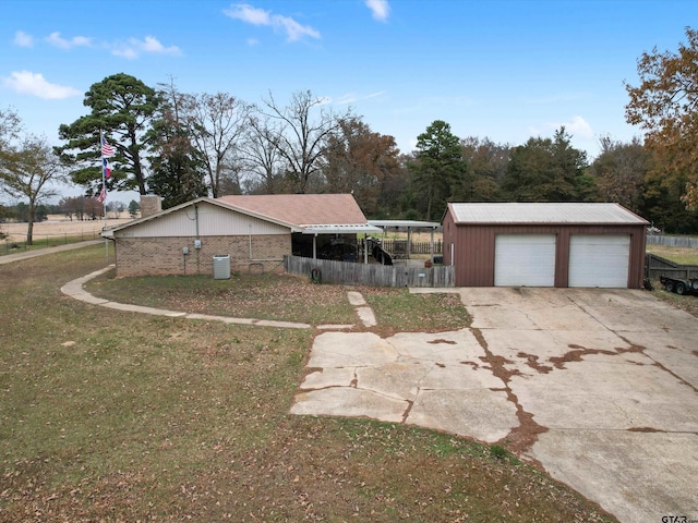 view of home's exterior with a yard, an outbuilding, and a garage