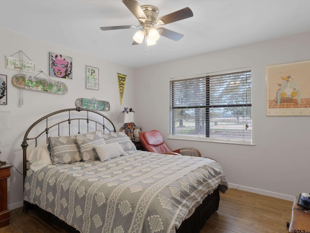 bedroom with ceiling fan and dark hardwood / wood-style floors