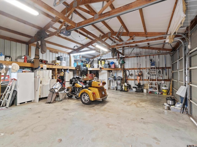 garage with white refrigerator with ice dispenser and a garage door opener