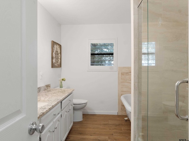 full bathroom featuring separate shower and tub, hardwood / wood-style flooring, vanity, and toilet