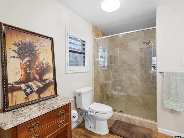 bathroom with toilet, a shower with shower door, and wood-type flooring