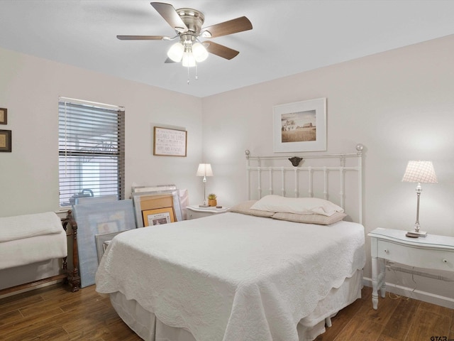 bedroom with ceiling fan and dark hardwood / wood-style flooring