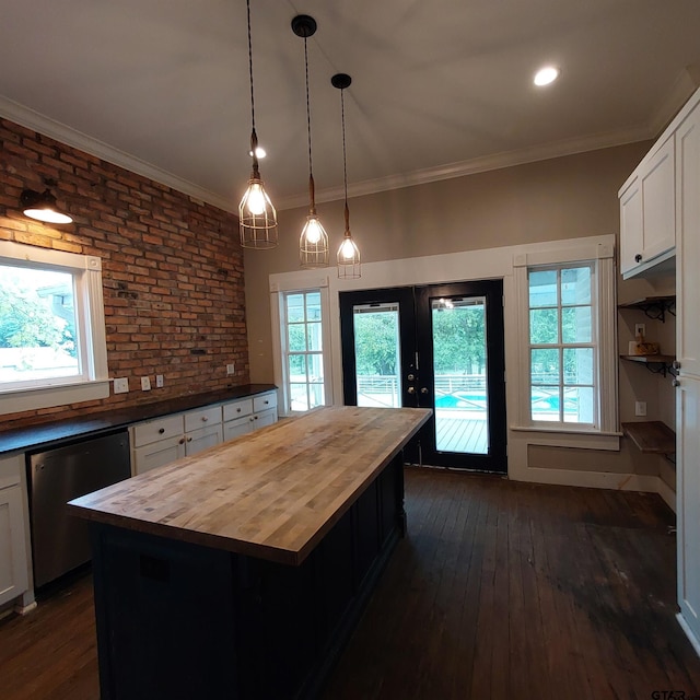 601 Holbrook St, Mount Vernon, TX 75457 - kitchen with butcher block counters, stainless steel dishwasher, dark wood finished floors, french doors, and white cabinets