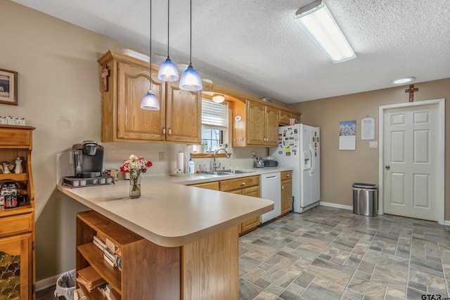 kitchen with white appliances, a textured ceiling, sink, hanging light fixtures, and kitchen peninsula