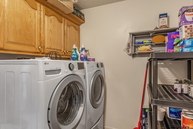 laundry area with cabinets, separate washer and dryer, and a textured ceiling