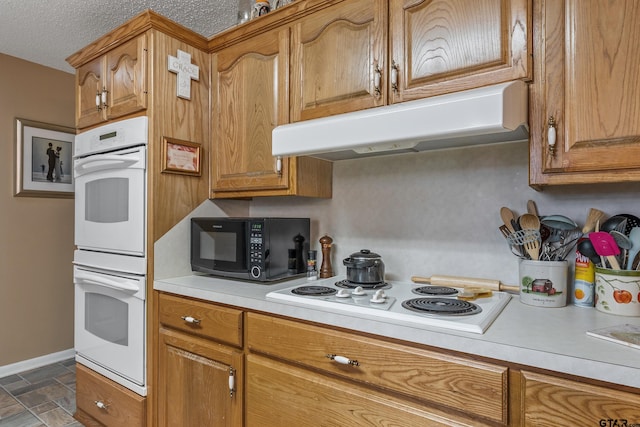 kitchen with white appliances and a textured ceiling