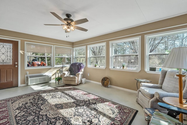 sunroom / solarium featuring ceiling fan and a wall mounted air conditioner