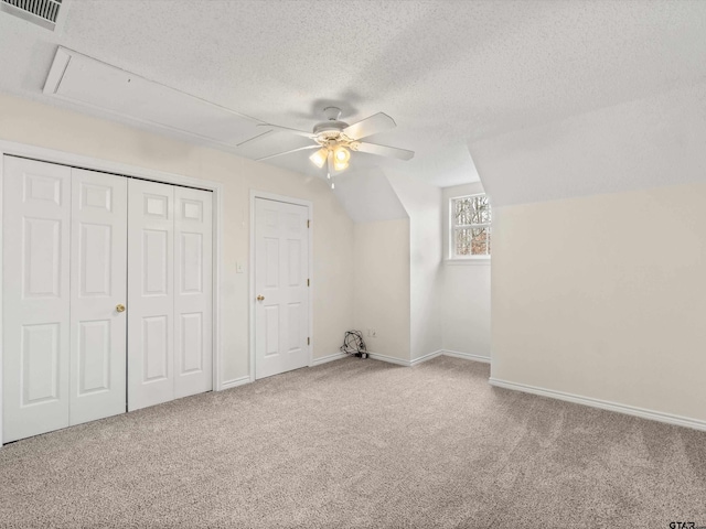 221 Butternut Gln, Holly Lake Ranch, TX 75765 - additional living space featuring attic access, a ceiling fan, carpet flooring, a textured ceiling, and baseboards