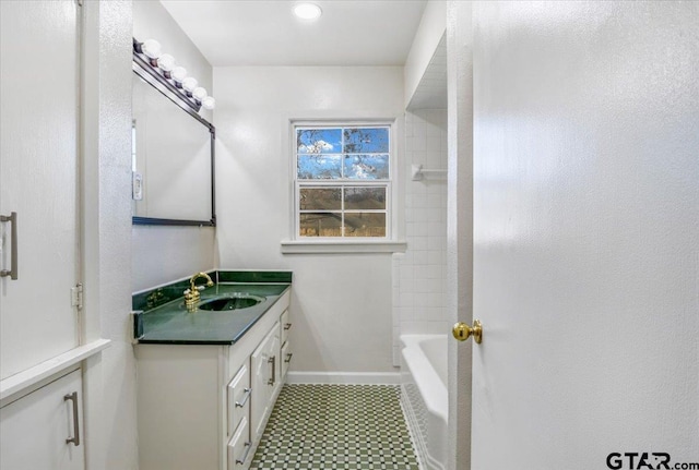 bathroom featuring vanity and tiled shower / bath