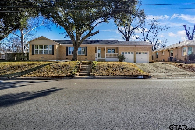 single story home with a garage and central AC