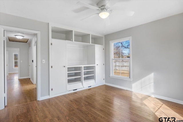 interior space with hardwood / wood-style floors, ceiling fan, and a closet