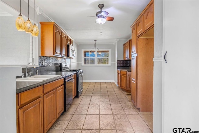 kitchen featuring crown molding, appliances with stainless steel finishes, sink, and decorative light fixtures