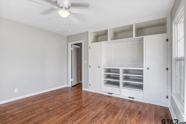 unfurnished bedroom with dark wood-type flooring and ceiling fan