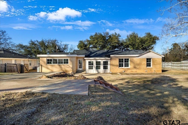 back of property featuring a lawn