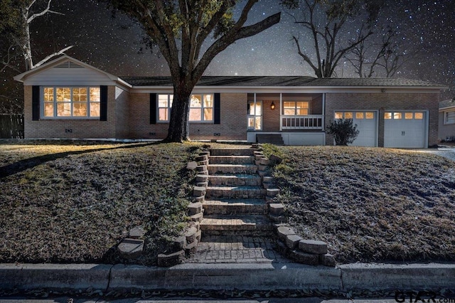 view of front facade with a garage and covered porch