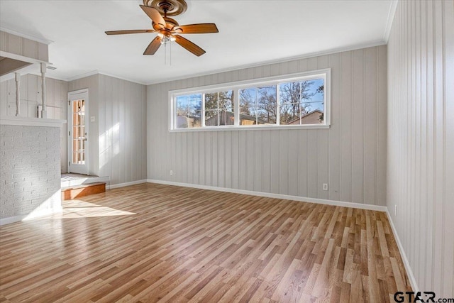 spare room with ceiling fan, ornamental molding, and light hardwood / wood-style floors