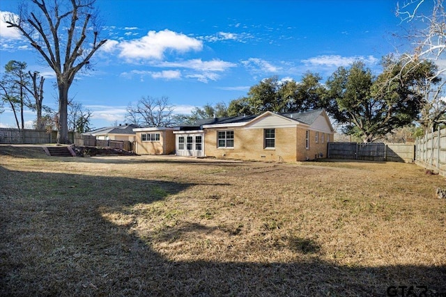 back of house with a lawn