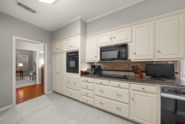 kitchen with dark stone countertops, visible vents, decorative backsplash, black appliances, and ornamental molding