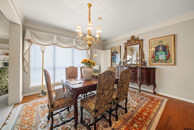dining area with a textured ceiling, a notable chandelier, and ornamental molding