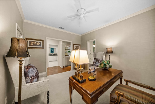 interior space with carpet, visible vents, a ceiling fan, and ornamental molding