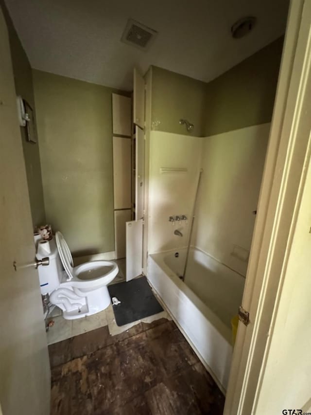 full bathroom with toilet,  shower combination, and visible vents