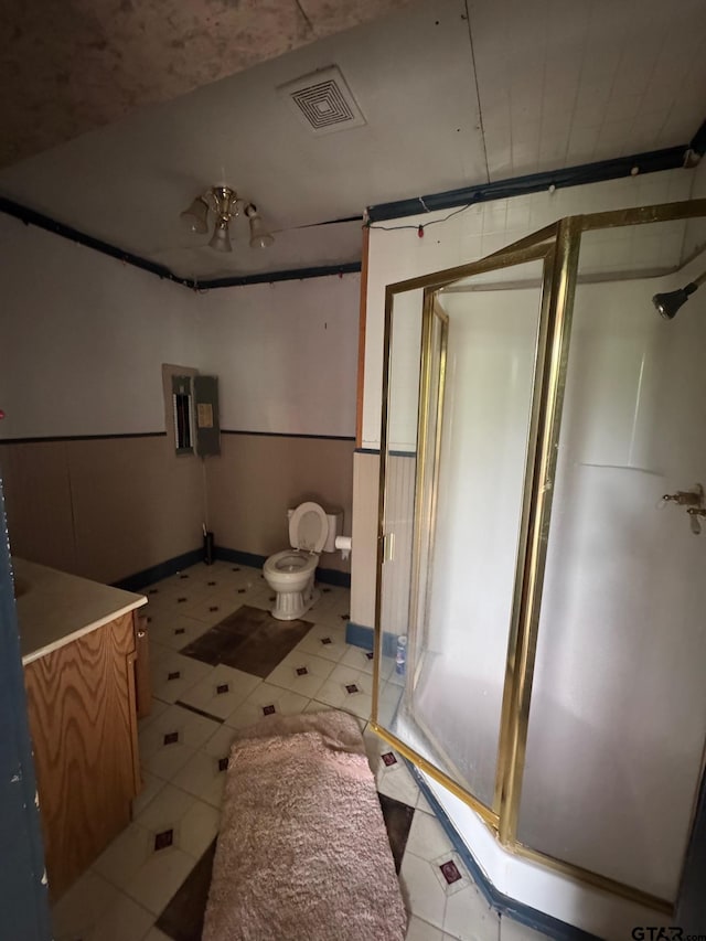 bathroom featuring vanity, toilet, visible vents, and a stall shower