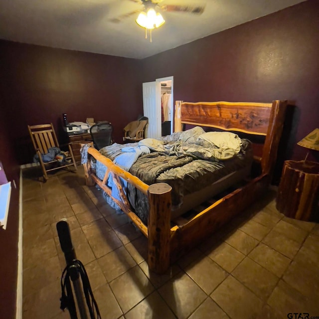 bedroom with ceiling fan and tile patterned flooring