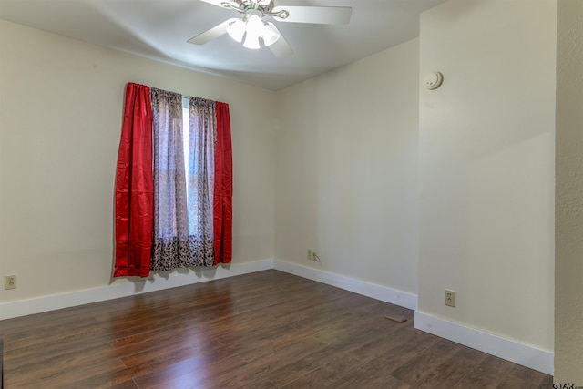 empty room featuring ceiling fan and dark hardwood / wood-style floors