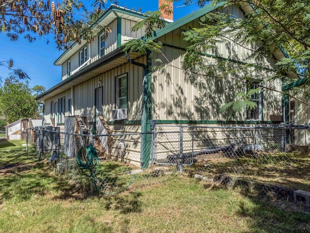 view of side of home featuring a lawn