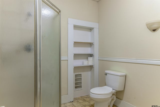 bathroom featuring toilet and walk in shower